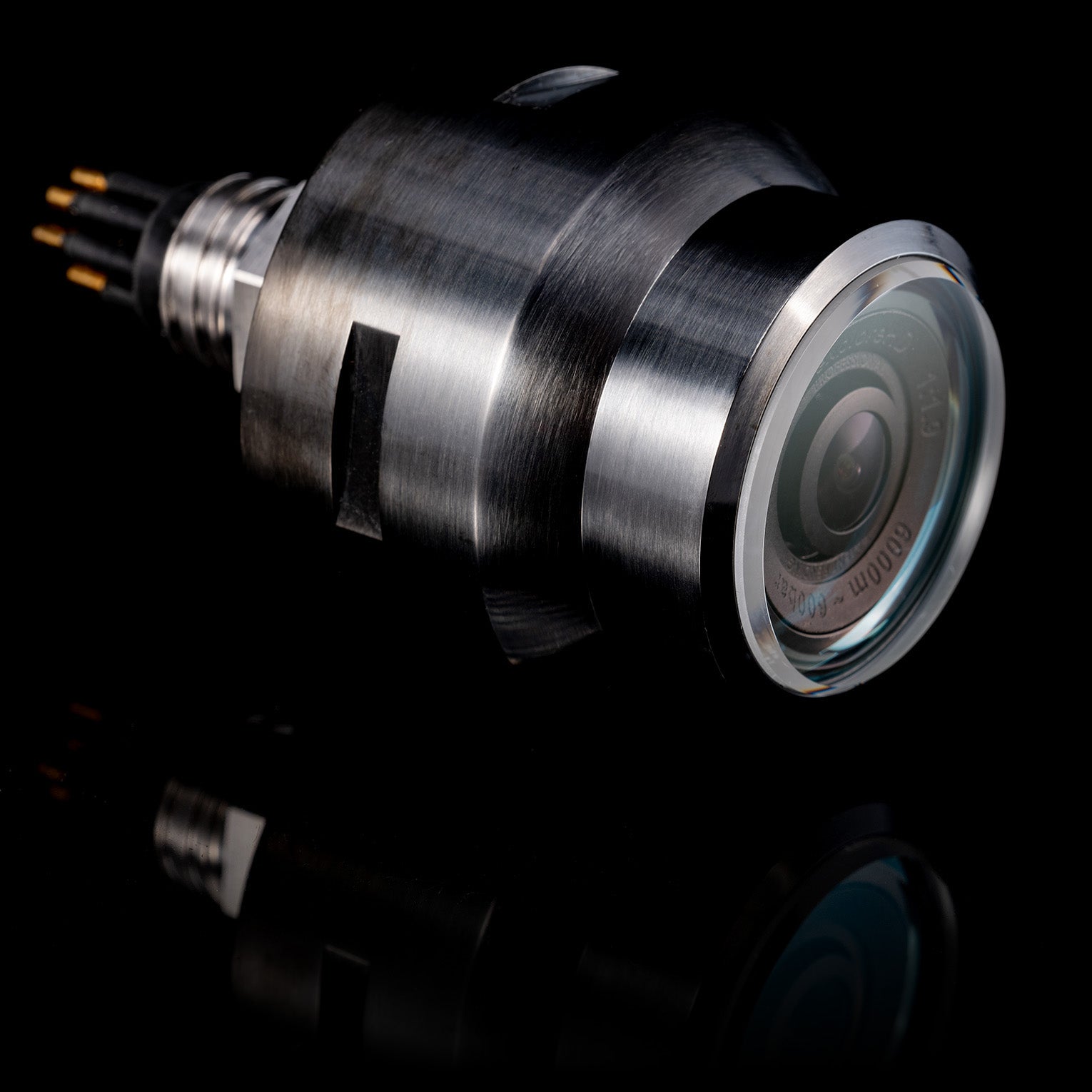 The DeepWater Exploration exploreHD Pro, a professional 6000m depth-rated subsea camera, showcasing its Diamond-Like Carbon (DLC) coated titanium housing, scratch-resistant sapphire lens port, and robust connector. Engineered for full ocean-depth ROV/AUV imaging and extreme underwater exploration.