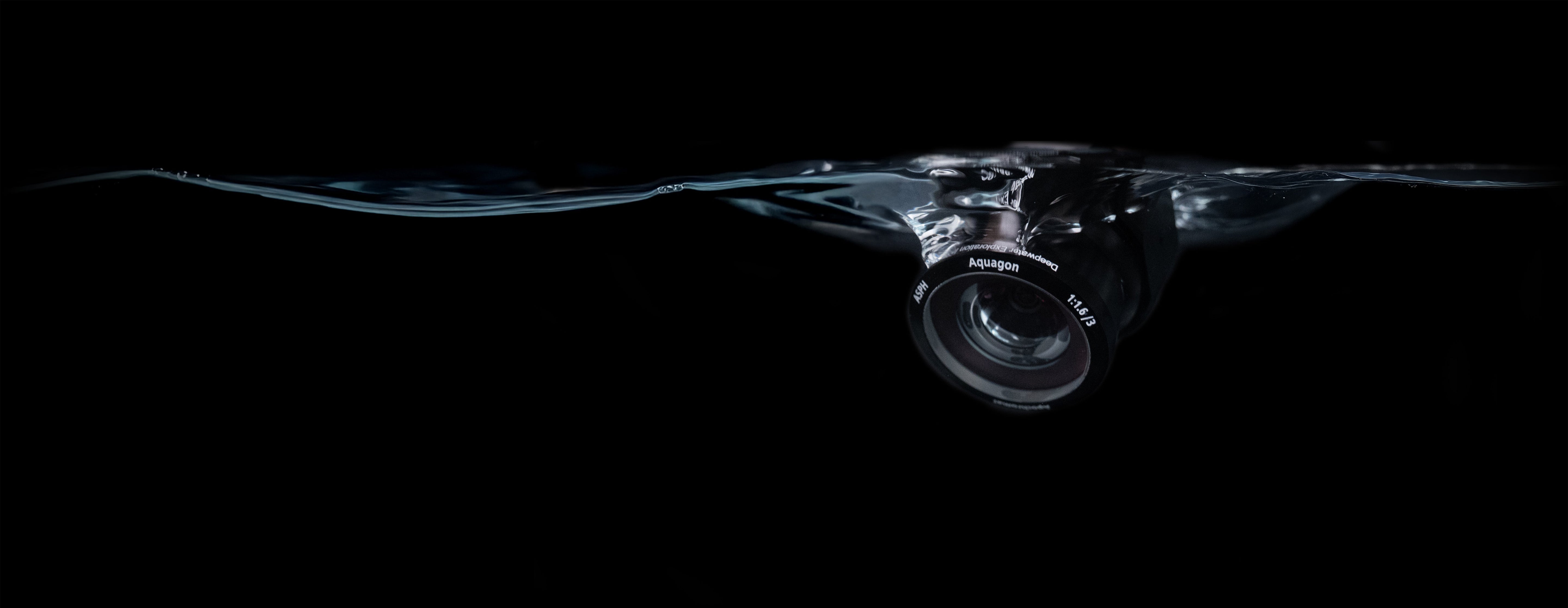 An advanced DWE camera featuring the precision Aquagon™ lens, captured during water immersion. This system is designed for critical underwater tasks requiring high-resolution, non-distorting images, such as subsea 3D imaging and detailed surveys.