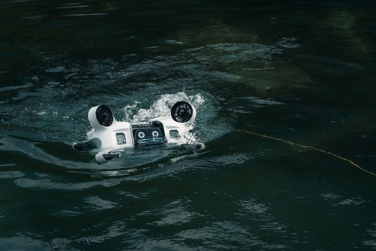 A submersible underwater drone floating on the water’s surface, designed for marine exploration, search and recovery operations, and subsea inspection. Equipped with high-resolution cameras and advanced navigation systems, this remotely operated vehicle (ROV) provides real-time imaging in harsh aquatic environments.