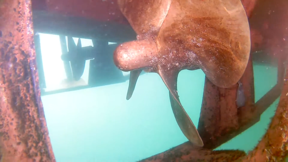 Underwater inspection of a ship propeller and hull, showing corrosion and marine growth. Captured using a high-resolution subsea camera, this imaging is essential for marine infrastructure inspection, vessel maintenance, and offshore asset monitoring to ensure operational efficiency and safety.